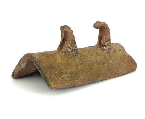 A Medieval pottery ridge tile, with two thorn fins to the top, green glazed earthenware, 54cm long