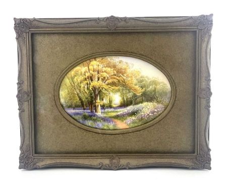 R Rushton for Royal Worcester, a landscape painted plaque, Bluebell Hew, depicting a woodland path with bluebells, puce mark,