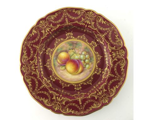 Telford for Royal Worcester, a fruit painted plate, decorated with peaches and grapes within a red ground raised gilt foliate