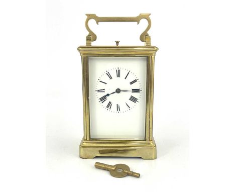 A repeating carriage clock, early 20th Century, brass corniche case with swing handle, visible escapement window, white ename