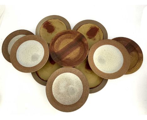 Robin Welch, a harlequin set of ten studio pottery plates, broad rimmed stoneware, four with plain oatmeal glazed centres, fo