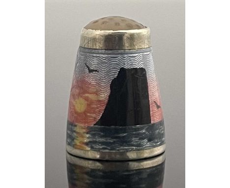 A Norwegian silver and enamelled thimble, KH, decorated in the round with a seascape at sunset with rock island, set with a j