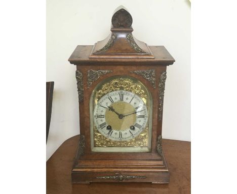 E. Robinson, Ludlow, a late Victorian burr walnut bracket clock, circa 1890, of Baroque design with pediment, brass finials, 