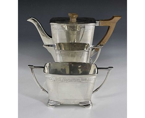 A George VI silver three piece tea set, Stower and Wragg, Sheffield 1939, Art Deco style bowed cuboid form with angled handle