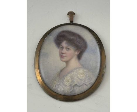 An Edwardian portrait miniature, oval, depicting a dark haired woman in lace shouldered dress, signed indistinctly, 7.5cm 5.5