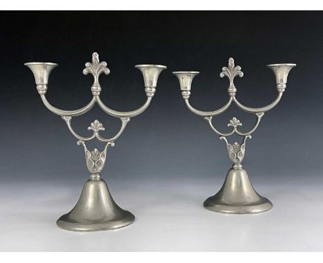 BH Edlunds for Svenskt Tenn, a pair of pewter two branch candelabra, 1928, the trumpet form bases supporting foliate moulded 