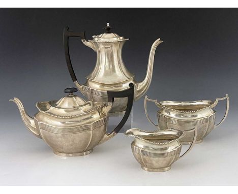 An Edwardian silver four piece tea and coffee set, Barker Brothers, London 1907, ogee section boat form, gadrooned rims, ebon