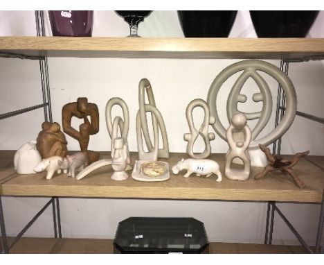 FULL SHELF OF STONE ORNAMENTS , SOME WOOD