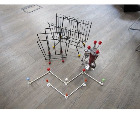 A collection of 1950's metal ware including two Sputnik ball style coat hangers, two ball footed magazine racks, and a firesi