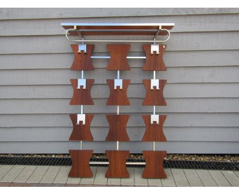 A wall hanging wood and metal coat rack 