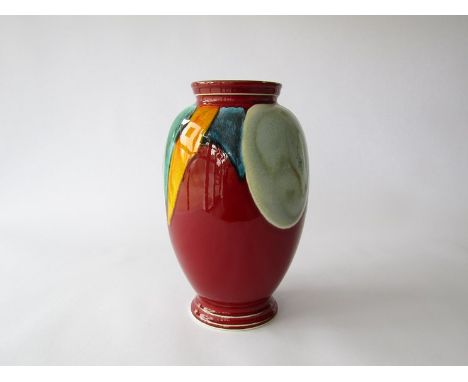 A Poole pottery 'Living Glaze' range vase, red ground with blue, turquoise and yellow. Marks to base. 22.5cm high