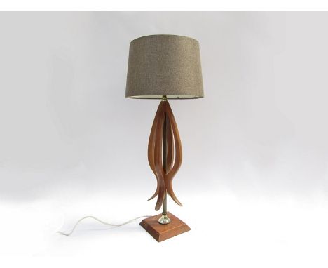 A teak and metal rod table lamp base of organic form, later shade 
