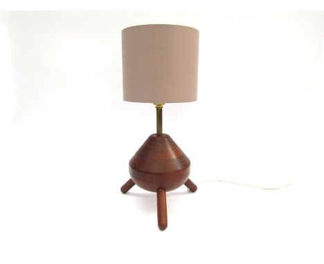 A mahogany table lamp base on three supports, modern shade. Base 15.5cm high