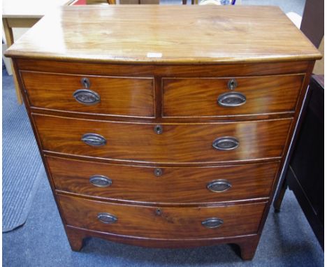 A Victorian bow front chest of two short cockbeaded drawers over three graduated long, oval escutcheons, swing handles, sprea