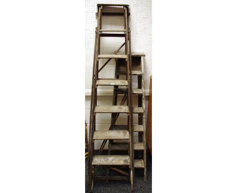 Two sets of vintage step ladders.