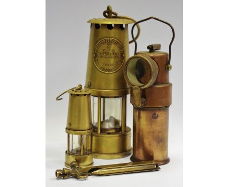 A C.O.A.G Type B.E.3 Miners Safety Lamp, an Eccles projector lamp, a miniature miners lamp, a miners deputy's pricker, detona