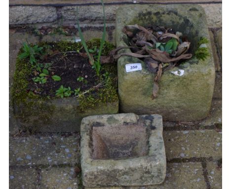 A miniature Derbyshire gritstone trough; another two,larger, composite (3)