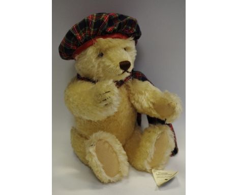 A Steiff teddy bear, with 'growling' mechanism, tartan dress, with labels  