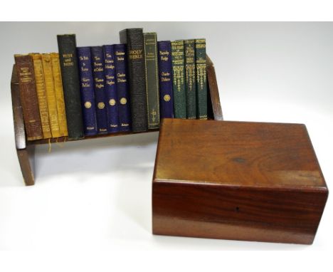 An oak book trough and books including Hilaire Belloc; Charles Dickens; Thomas Hughes; a mahogany deed box. (2)