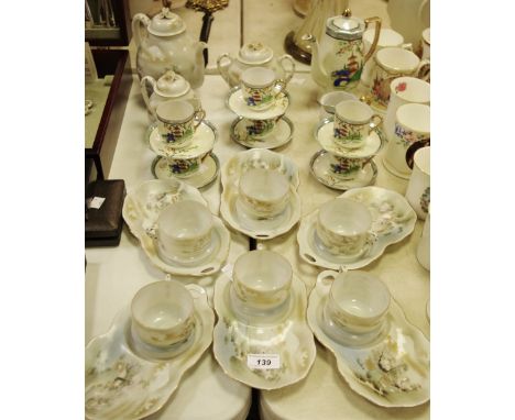 A Japanese eggshell tea service and a Japanese coffee service comprising teapot/coffee pot, cups, saucers, sugar bowl and mil