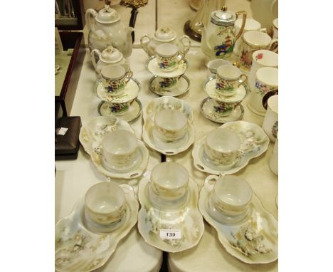 A Japanese eggshell tea service and a Japanese coffee service comprising teapot/coffee pot, cups, saucers, sugar bowl and mil