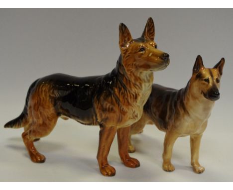 A Goebel porcelain model of an Alsatian in standing pose, modelled by Gerhard Skrobek, printed marks to base; a Royal Doulton