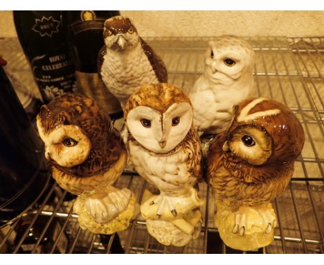 Four Beswick owl whisky decanters and a Beneagles Osprey decanter with contents
