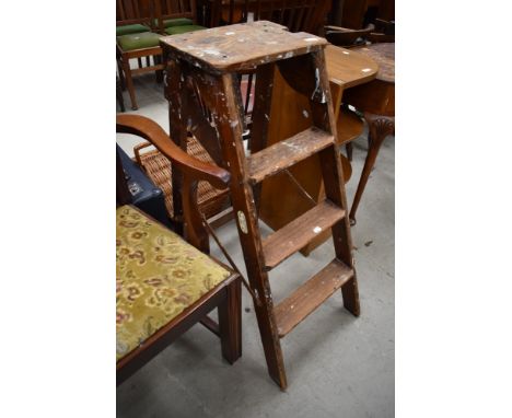 A set of vintage wooden step ladders, labelled for Slingsby