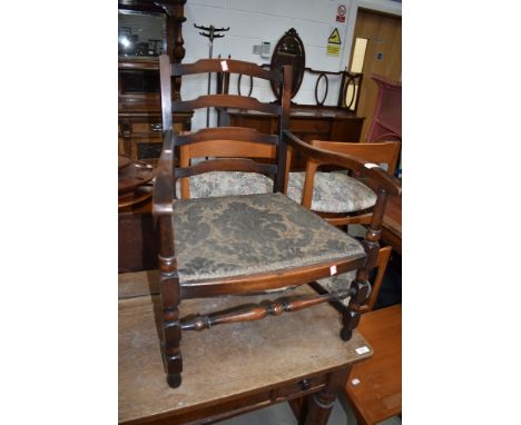 A traditional stained frame low seat carver chair having ladder back