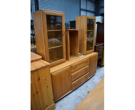 A modern light stained side board or dresser base by Ercol with glazed cabinets