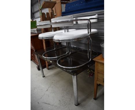 A vintage chrome framed and black glass dining table with four chrome and white vinyl modernist chairs
