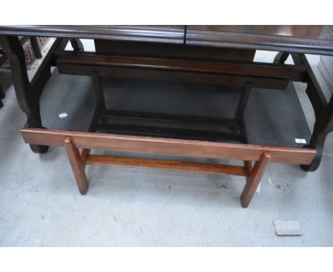 A vintage stained frame coffee table having smoked glass top