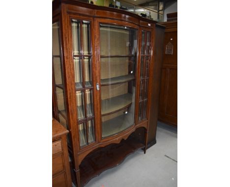 An Edwardian mahogany and inlaid display cabinet having lined interior, central bow front, on square tapered legs, dimensions