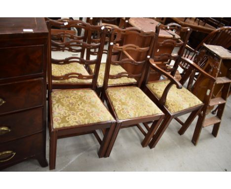 A set of five (four plus one) early 20th Century mahogany dining chairs having slit ladder backs
