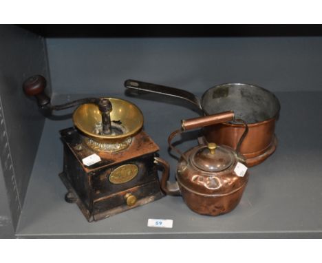 A vintage cast metal and brass coffee grinder, a copper pan and a small kettle.
