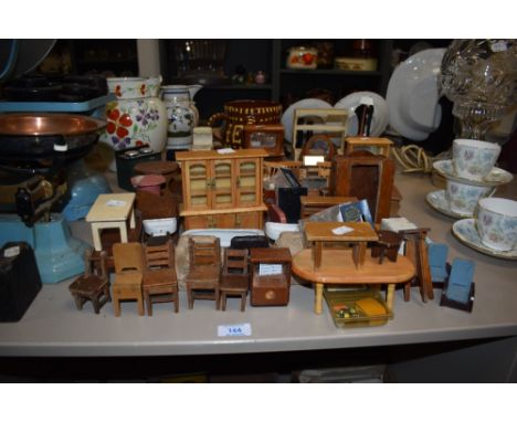 An assortment of vintage dolls house furniture.