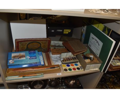 An array of vintage and modern craft and artists supplies, including watercolour paints, brushes, reference books and more.