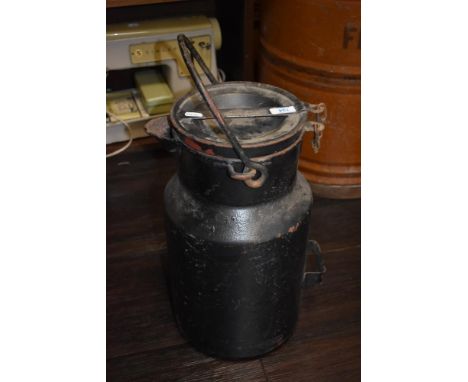 A vintage painted milk churn.