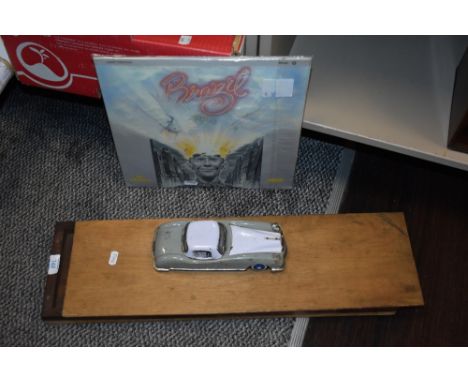 A vintage wooden printing block tray, a LP record 'Brazil' and a vintage tin toy car.