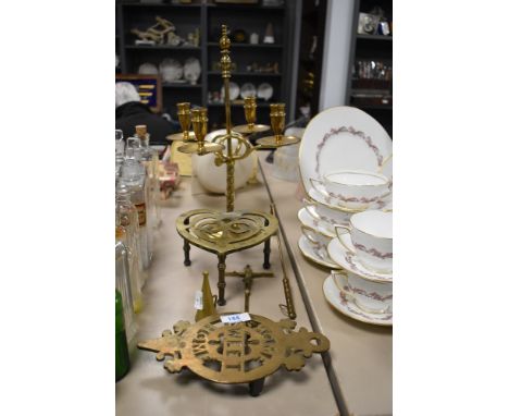 A selection of vintage brass, including candlestick, two snuffers and two trivets.