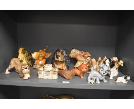 An assortment of ceramic and chalkware dog studies, including Wade Lady and the Tramp whimsies.