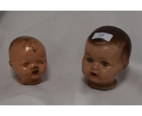 Two vintage cast-composite dolls heads, painted with wear