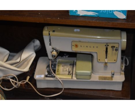 A 1960s Singer 449 sewing machine, with manual, pedal and case.