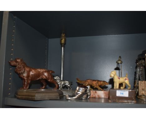An Art Deco cast metal paperweight/pin dish, a lamp base, pen holder, pin cusion and similar, all of dog related interest.