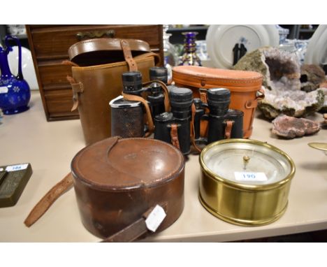 An early 20th century brass cased barometer 'Horne &amp; Thornthwaite London' two pairs of vintage binoculars and a leather c