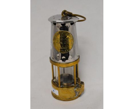 A brass and chromed metal miners safety lamp, number 224, 'The Protector Lamp Lighting Co Ltd' 25cm
