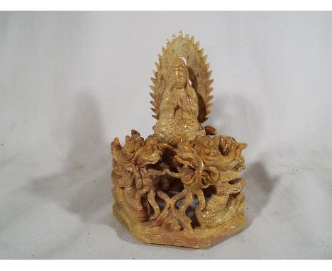 A highly carved fine, good quality Chinese soapstone statue depicting a Goddess surrounded by dragons 15 cm (h) Estimate £80 