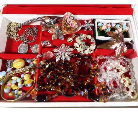 A jewellery box containing a collection of predominantly vintage costume jewellery, a silver ring set with marcasite, silver 