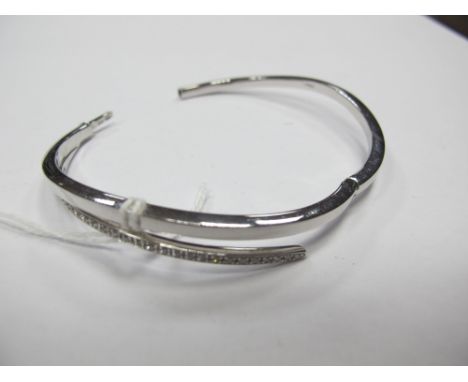 A Modern 9ct White Gold Bangle, inset to the front, hinged to snap clasp. 