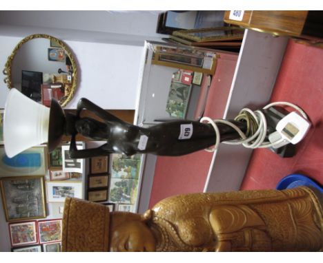 A Art Deco Style Bronzed Effect Table Lamp, of a nude holding a light shade. 